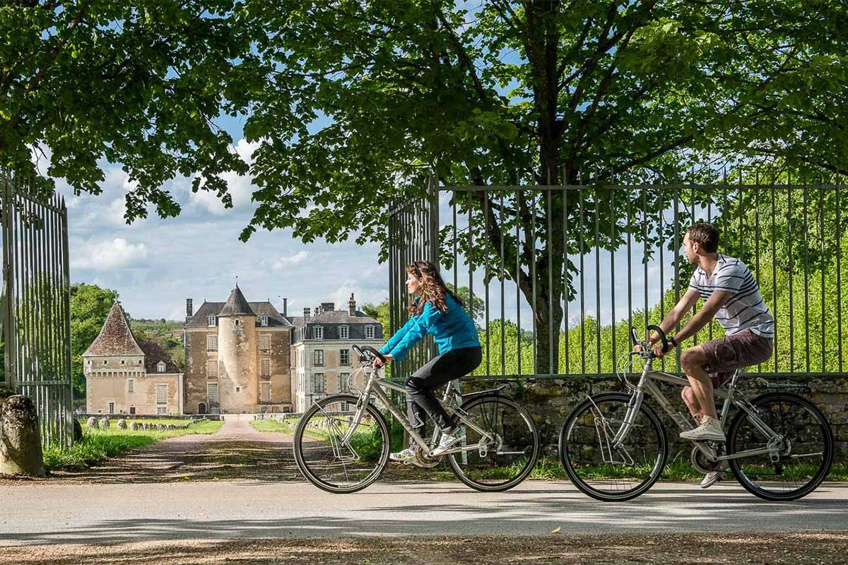 A couple cycling past a castle