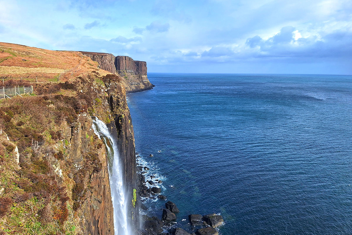 Cliffside waterfall plunging into the sea