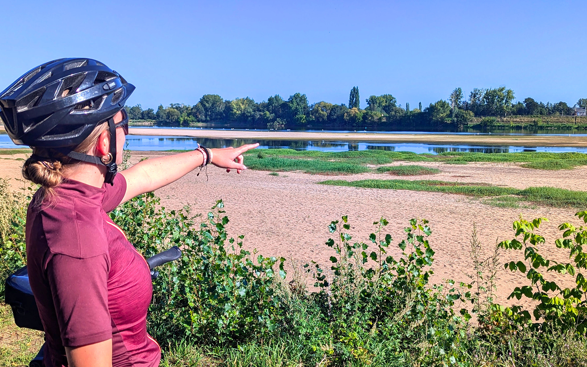 Cyclist pointing out the scenery on the Loire by Bike route