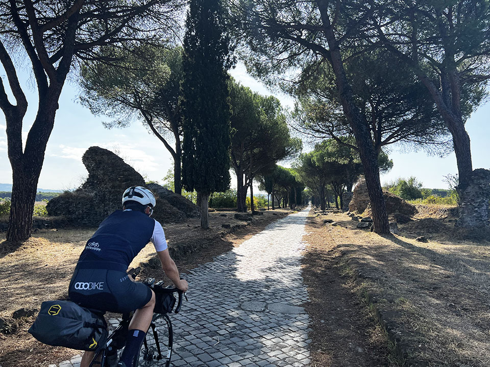 Cyclist on the Via Appia, ancient paved road