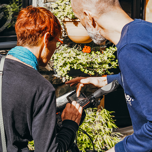 Welcome agent showing how a GPS work to a traveller