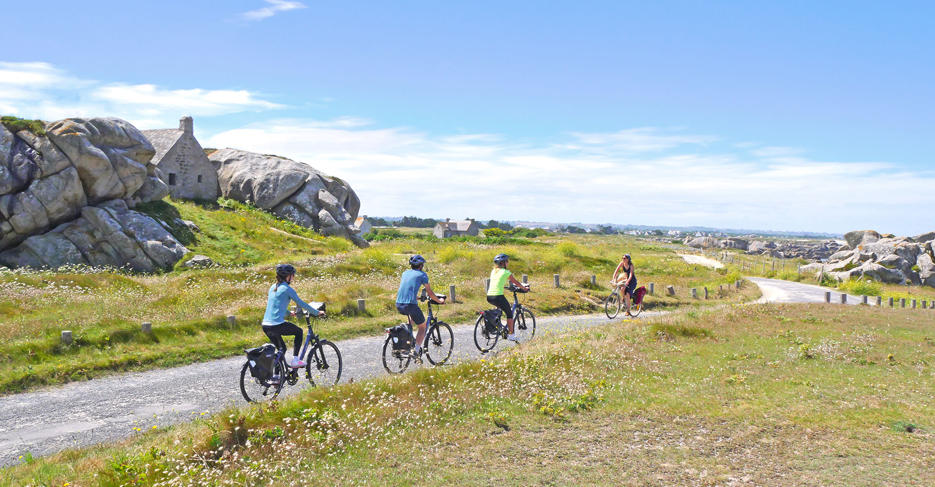 A group of cyclists ride along the green paths of Menez Ham in Brittany