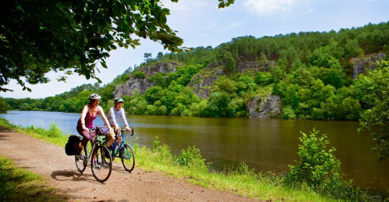 Couple de cyclistes sur le site de l'Ile aux pies sur la riviere de l'Oust