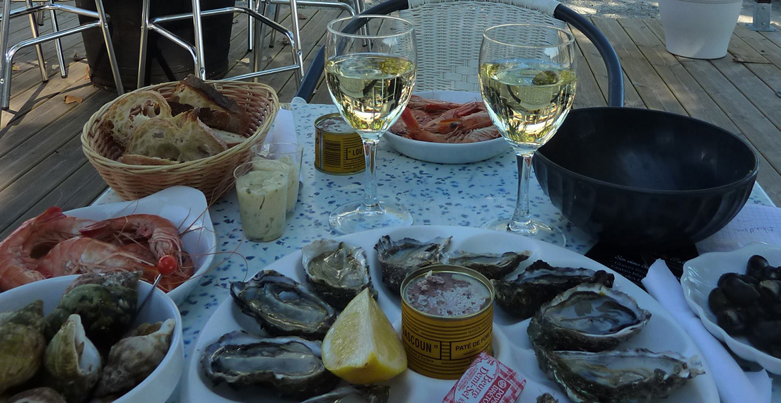 Une table dréssée des verres de vin et fruits de mer