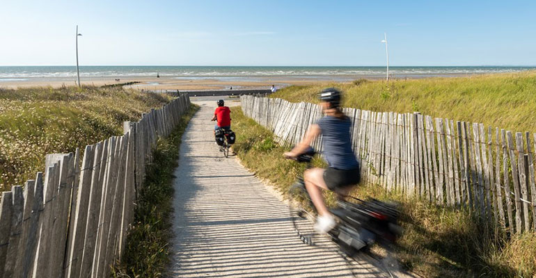 Cyclistes qui se baladent sur la plage de Cabourg