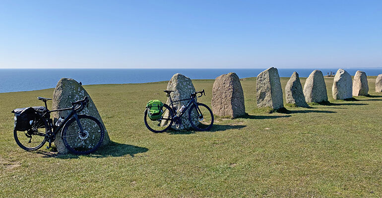 Deux vélos posés sur une rangée de Mégalithes