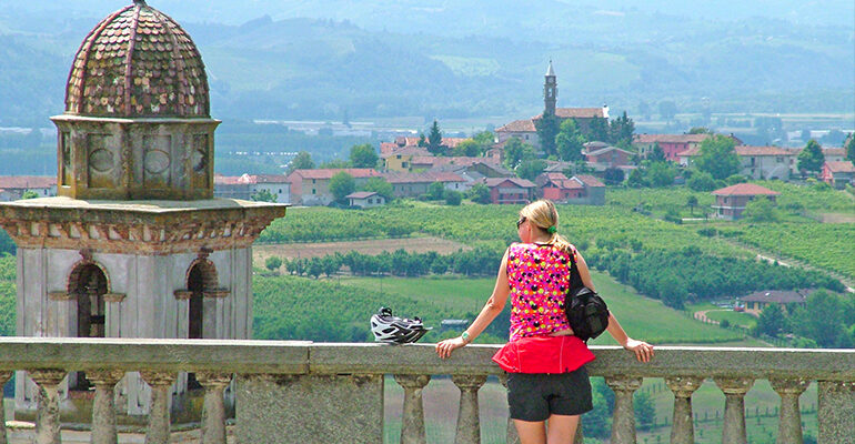 Une cycliste admirent le panorama sur la vallée du Piémont
